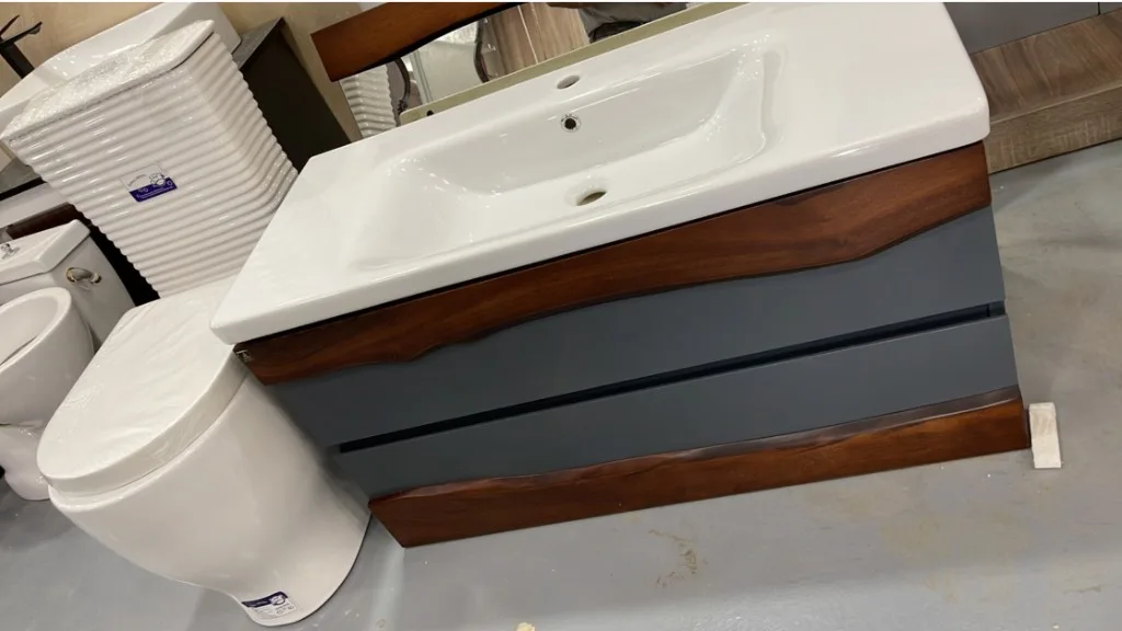 Floating slate vanity with live-edge wood trim and integrated ceramic basin