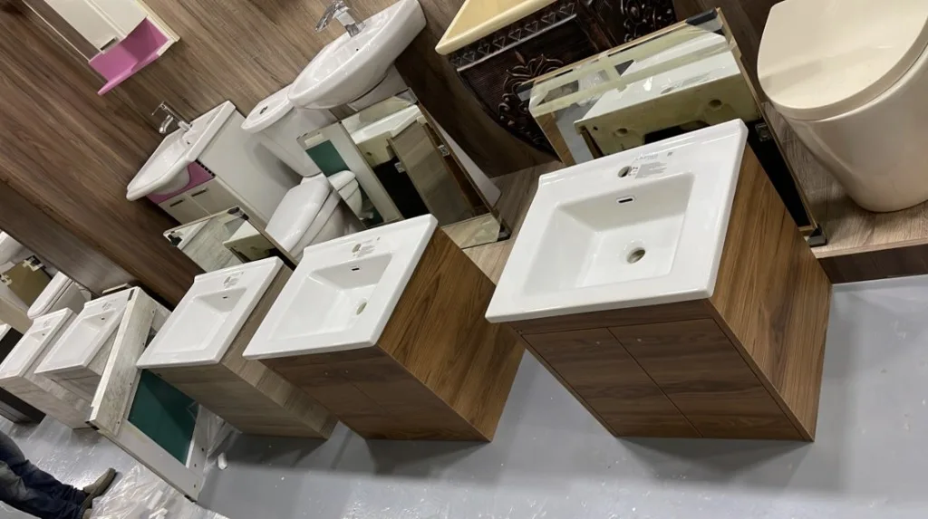 Wood-grain vanity cabinets with ceramic basins in a showroom display